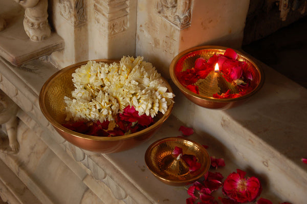 Copper and Brass 'Lau Diya Lamps' from AnanTaya Decor, with decorative flowers