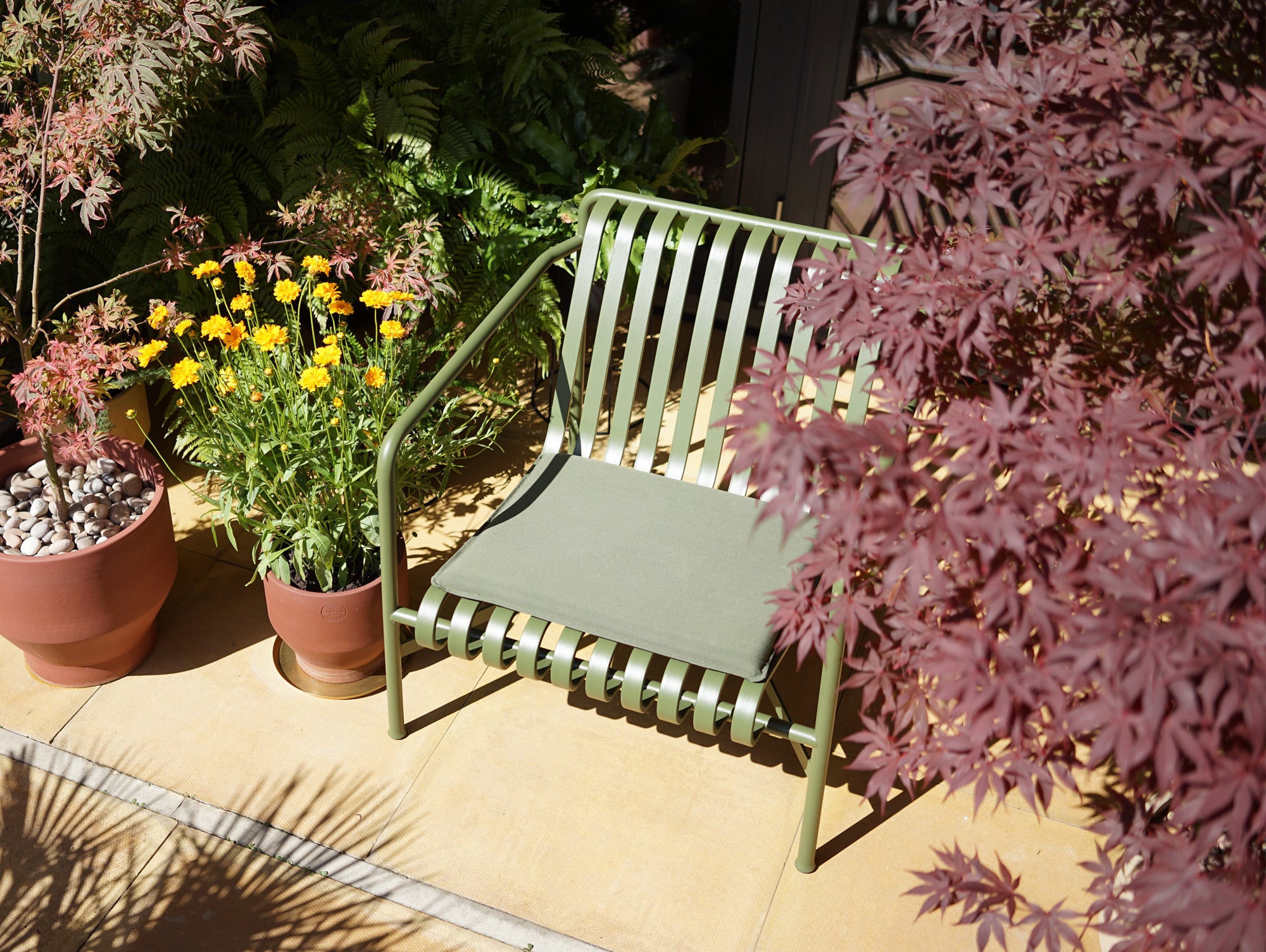 Palissade Lounge Chair and Cushion with Skagerak Edge Pots