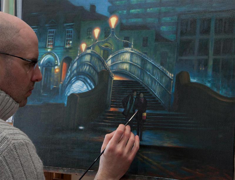Artist Vincent Keeling at his easel painting Lovers by the Hapenny Bridge