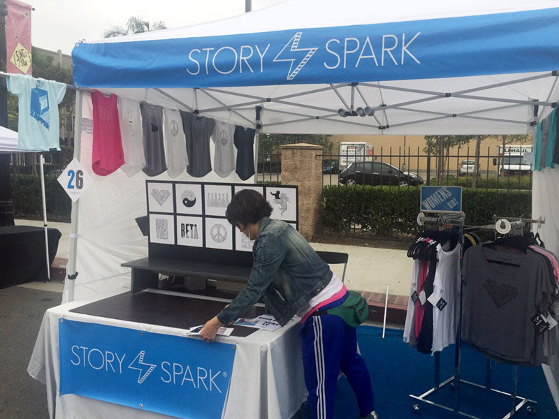 Setting up graphic t-shirts at the fair