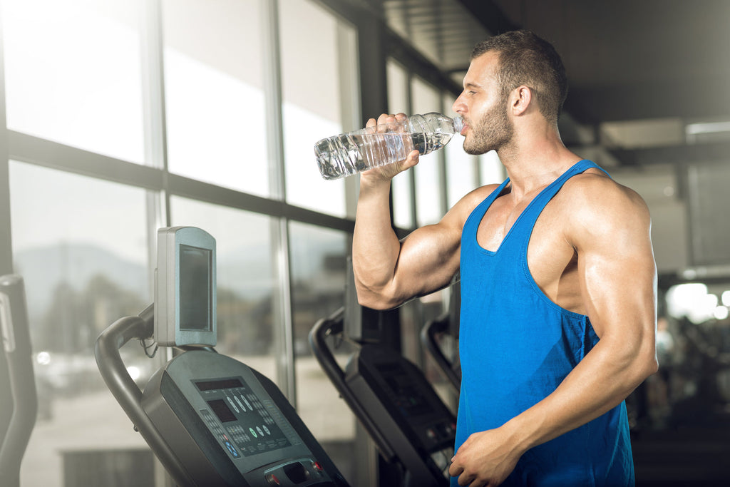 Man Drinking Water in Gym