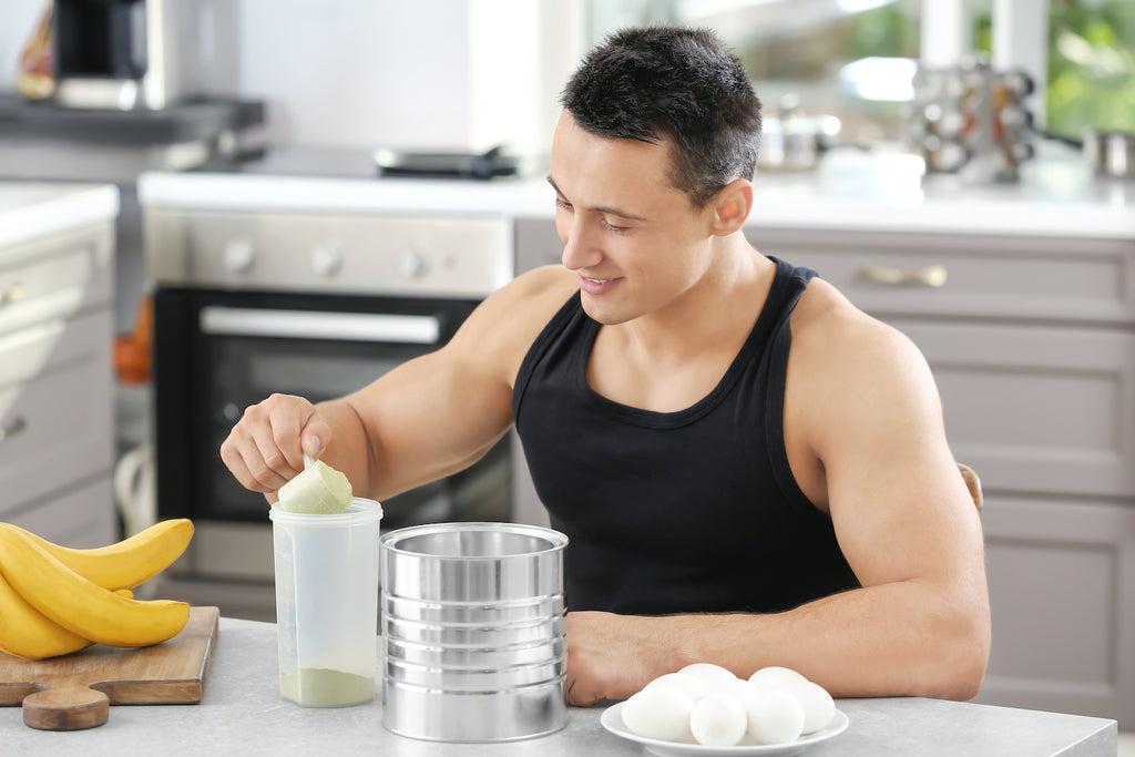 Best mass gainer: A man mixes a mass gainer shake