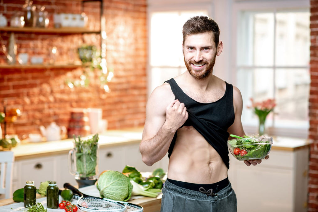 White man eating vegan diet for athletes while showing off muscles