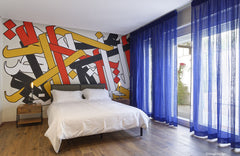 Bedroom of the youngest son, the white wall behind his bed was decorated by a local graffiti artist