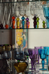 Glass storage in open cupboard in kitchen area