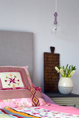 Master bedroom detail with colourful bedspread and cushion cover