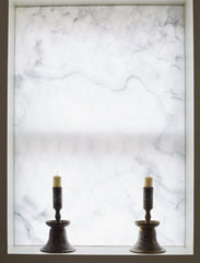 Privacy screen on a window facing the street, by using translucent onyx, light is allowed in during day time whilst the window is backlit at night time.