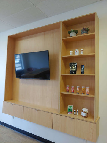 Wooden wall cabinet, television, shelves with items on them