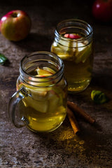 apple cider in mason jars with sliced apples