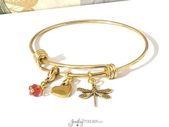 Gold bangle with charms