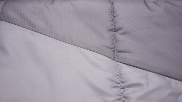 The Liner is Breathable 210T Polyester, the Outer Shell is Calendared 210T Ripstop Polyester