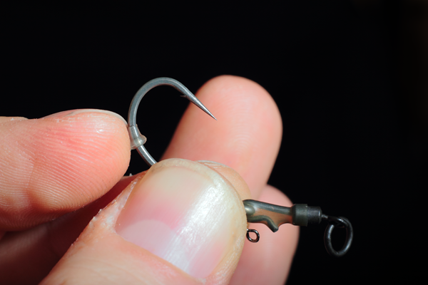 Slide one of our hook beads/shank stops onto the shank of the hook til its about opposite the barb