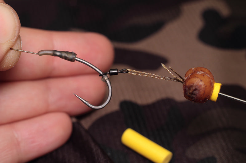 Load the tiger nut and foam onto a baiting needle and transfer onto the hair