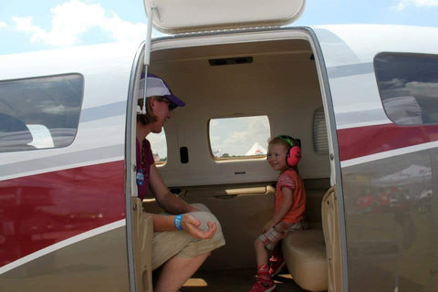 mom and daughter in a jet plane