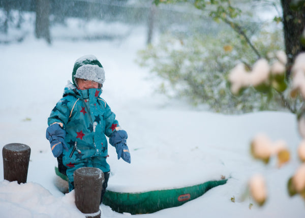 toddler playing in snow in Villervalla swedish snowgear from US Biddleandbop.com