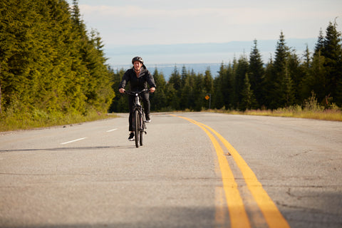 Woman riding up a hill on her e-bike