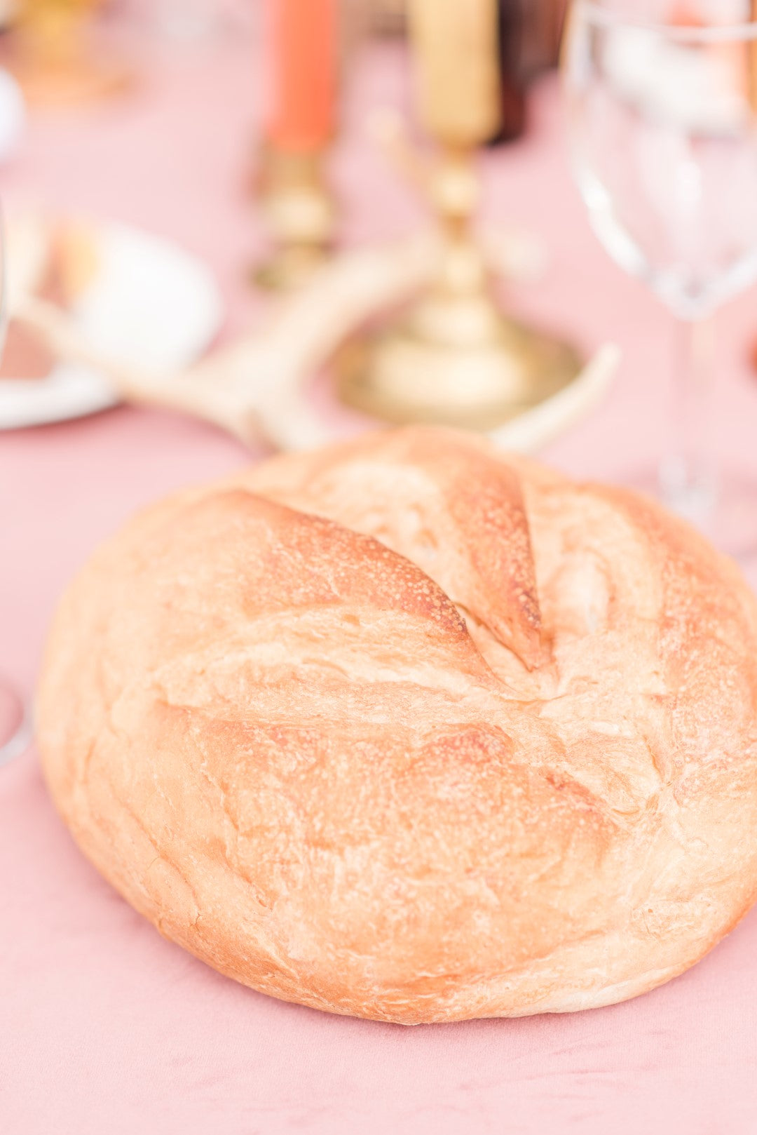 Breaking bread at a Thanksgiving Wedding Table