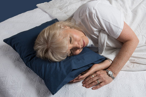 A woman comfortably rests on a pillowpacker pillow 
