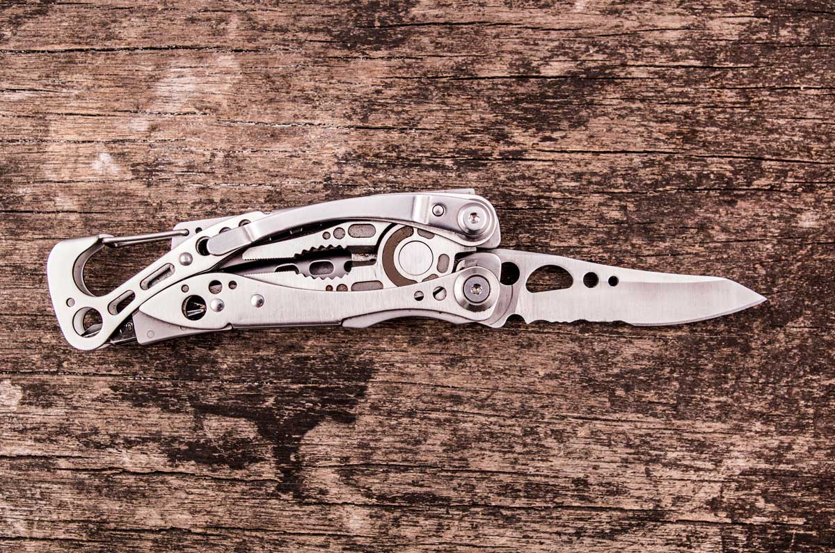 leatherman multitool sitting on weathered wood.