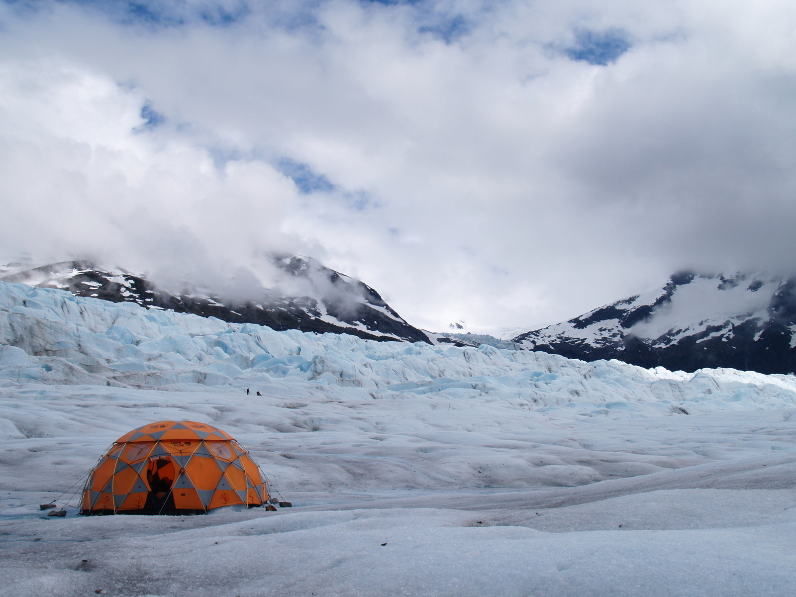 Winter camping: Cozy tent set up in cold and snowy environment.