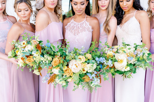 blush pink bridesmaids dresses with peach flowers