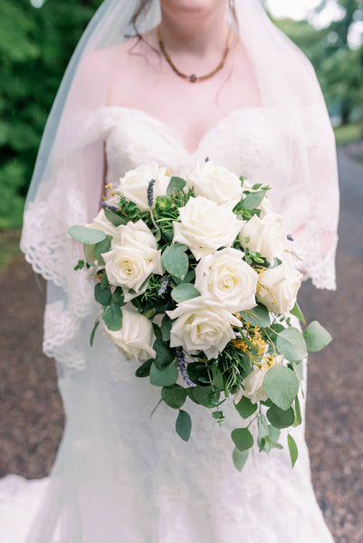 white wedding flowers roses and greenery