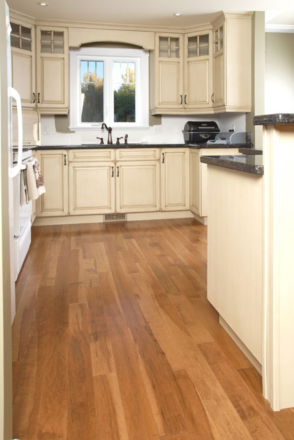 off white kitchen cabinets with a rustic wood flooring