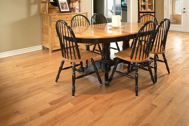 rustic hardwood flooring with a dark dining table