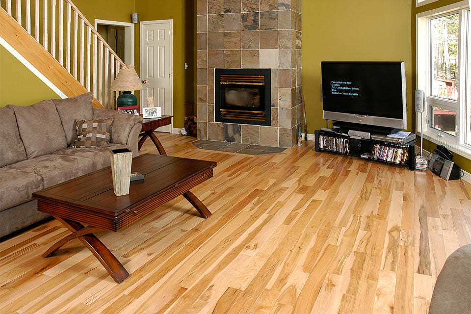 Natural maple wood flooring with a custom fireplace