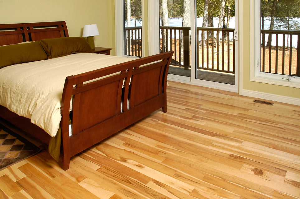 light maple flooring with a dark bed