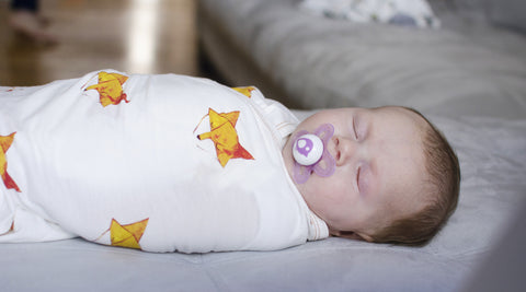 baby sleeping in swaddle blanket