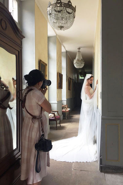 Amelia Soegijono photographing a bride wearing Madame Tulle Juliet cap veil