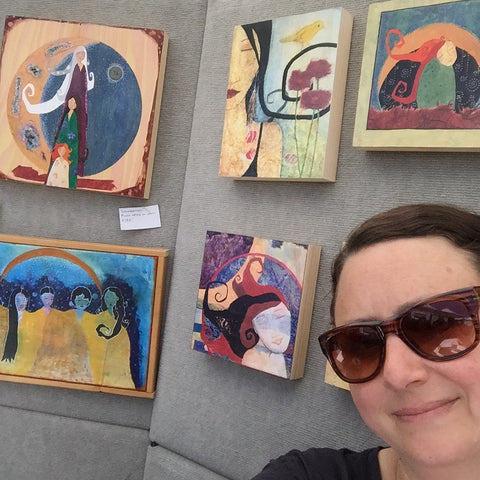 Lea K. Tawd artist in her booth at a festival