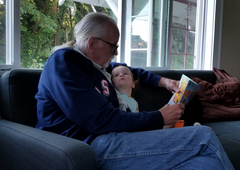 Dino-Buddies - Ed H reading with his beautiful new granddaughter, Lily