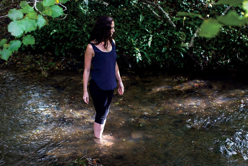 woman paddling in stream