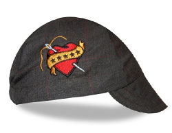 Side view of a gray wool cap with an embroidered heart tattoo design on the side.