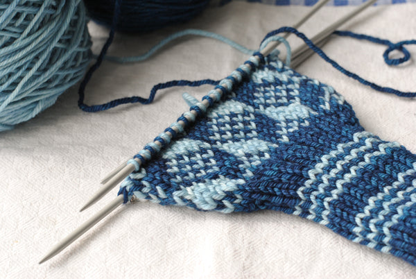 Cuff and partially knit hand of mitt in light and dark blue pattern