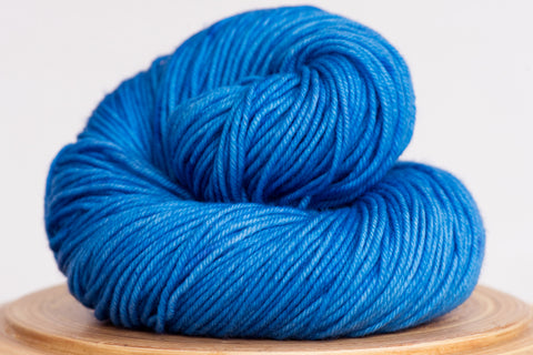 Minuet hand-dyed yarn in Azul colourway, bright blue with tiny bits of purple