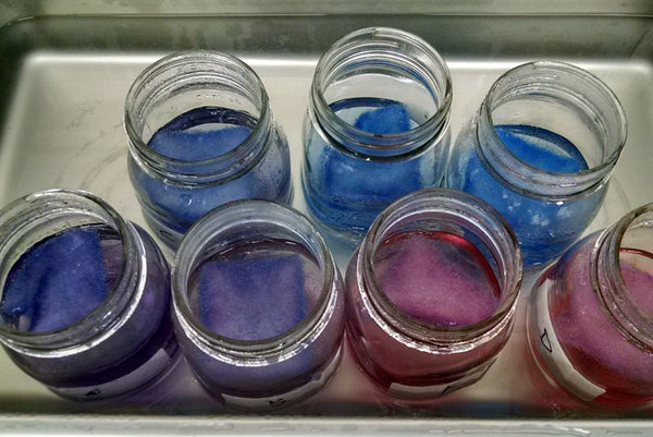 7 mason jars with dye colours from red to blue
