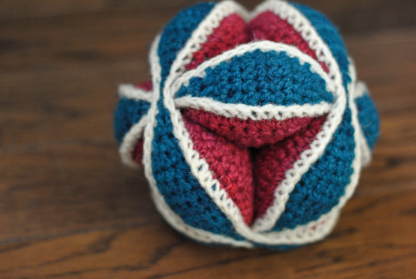 Amish puzzle ball in red, white, and teal