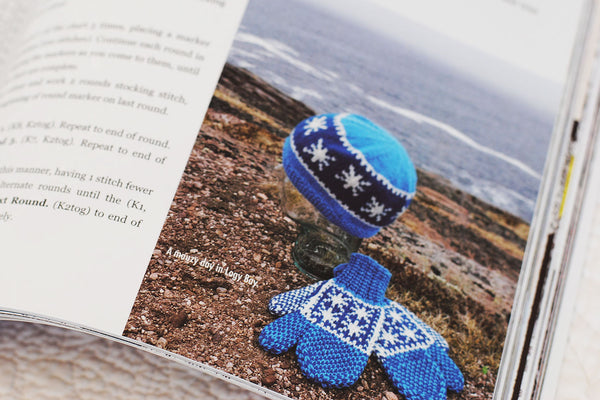Page from Saltwater Classics showing a set of handknit mittens and hat against a Newfoundland landscape