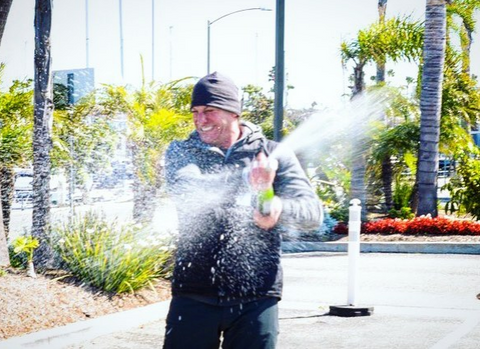 Frasca celebrates with a spray of bubbly upon completing his world record Cannonball Run.