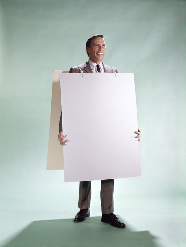 1960s smiling man wearing blank sandwich board posters & prints by Corbis