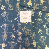 Caramel Macchito Bar sitting on sheets of gold and green robot patterned wrappers