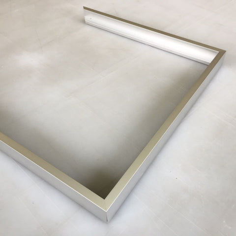 Slide an adjacent frame side onto the protruding corner plates and tighten with a screw driver. Repeat to create a U shape with three frame sides