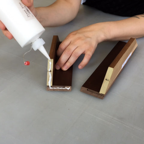 Wood glue is applied to the miters and the parts are placed together to form a corner