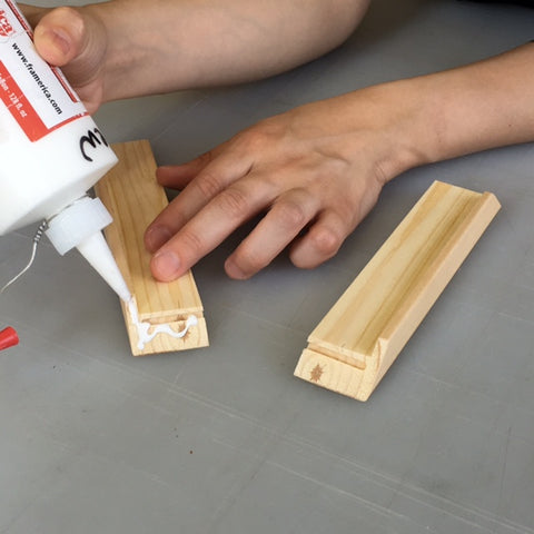 Wood glue is applied to the miters and the parts are placed together to form a corner