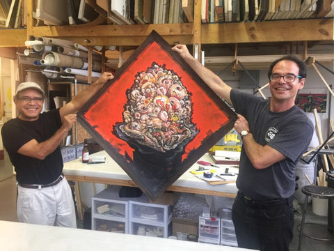 Jose Garcia Cordero and Frames and Stretcher co-founder Miguel Trelles holding up a finished piece.