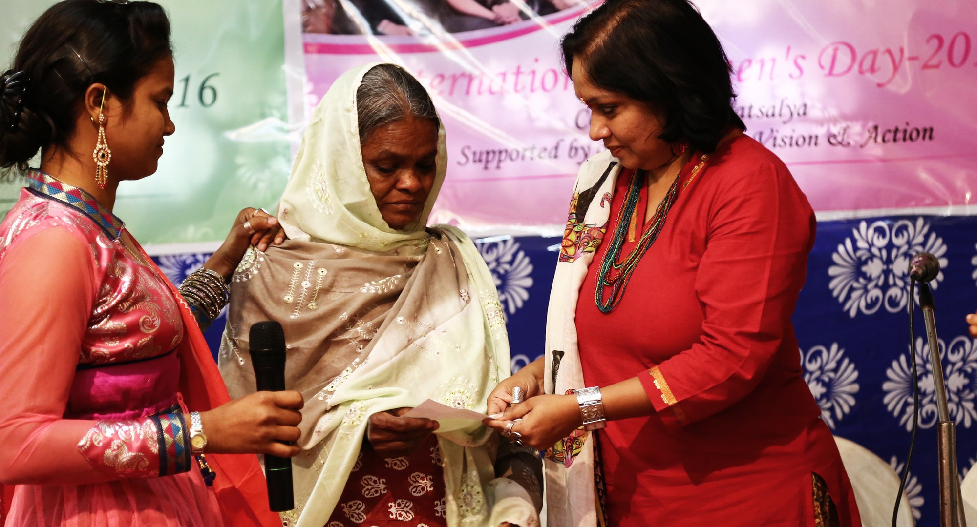 Nazia and mother accepting International Women's Day award