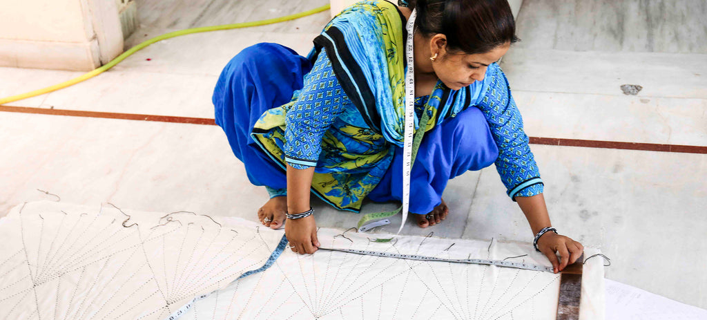 Anchal project assistant, Shama expertly measuring an Array quilt from the new Prism Collection